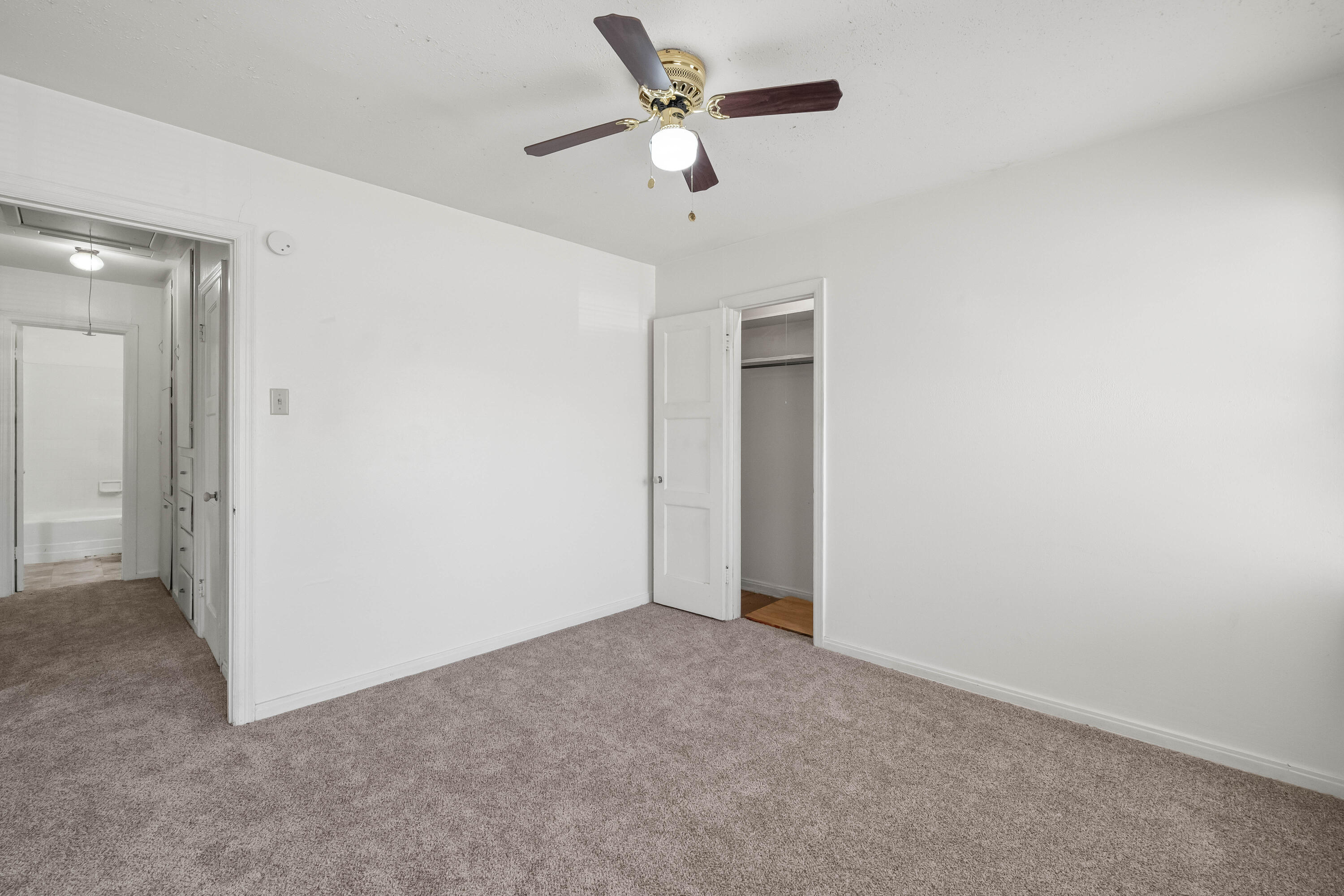 1718 46th Street Lubbock, TX 79412 - Photo 11 of 17 an empty room with closet and a ceiling fan