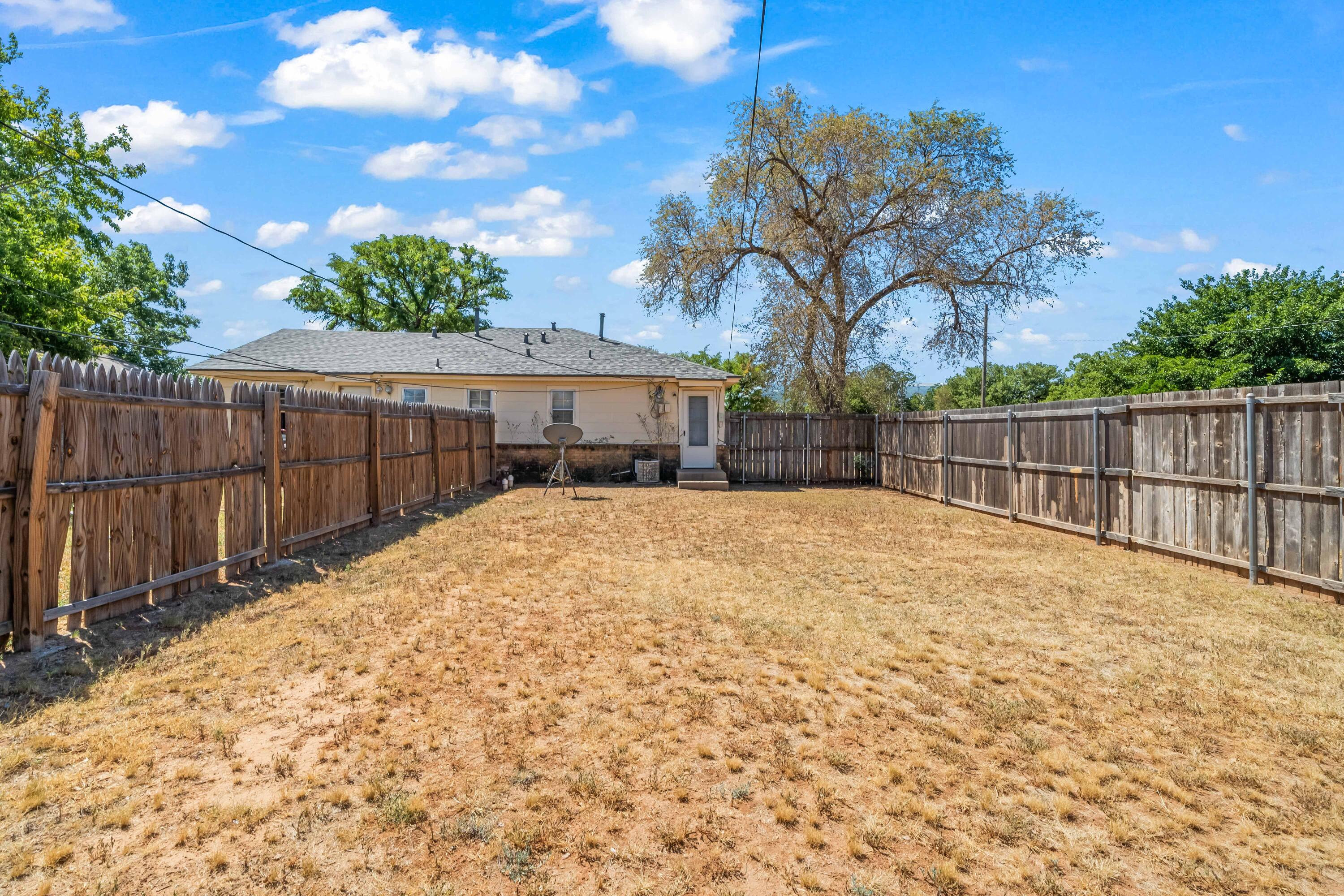 1718 46th Street Lubbock, TX 79412 - Photo 14 of 17 a view of backyard and trees