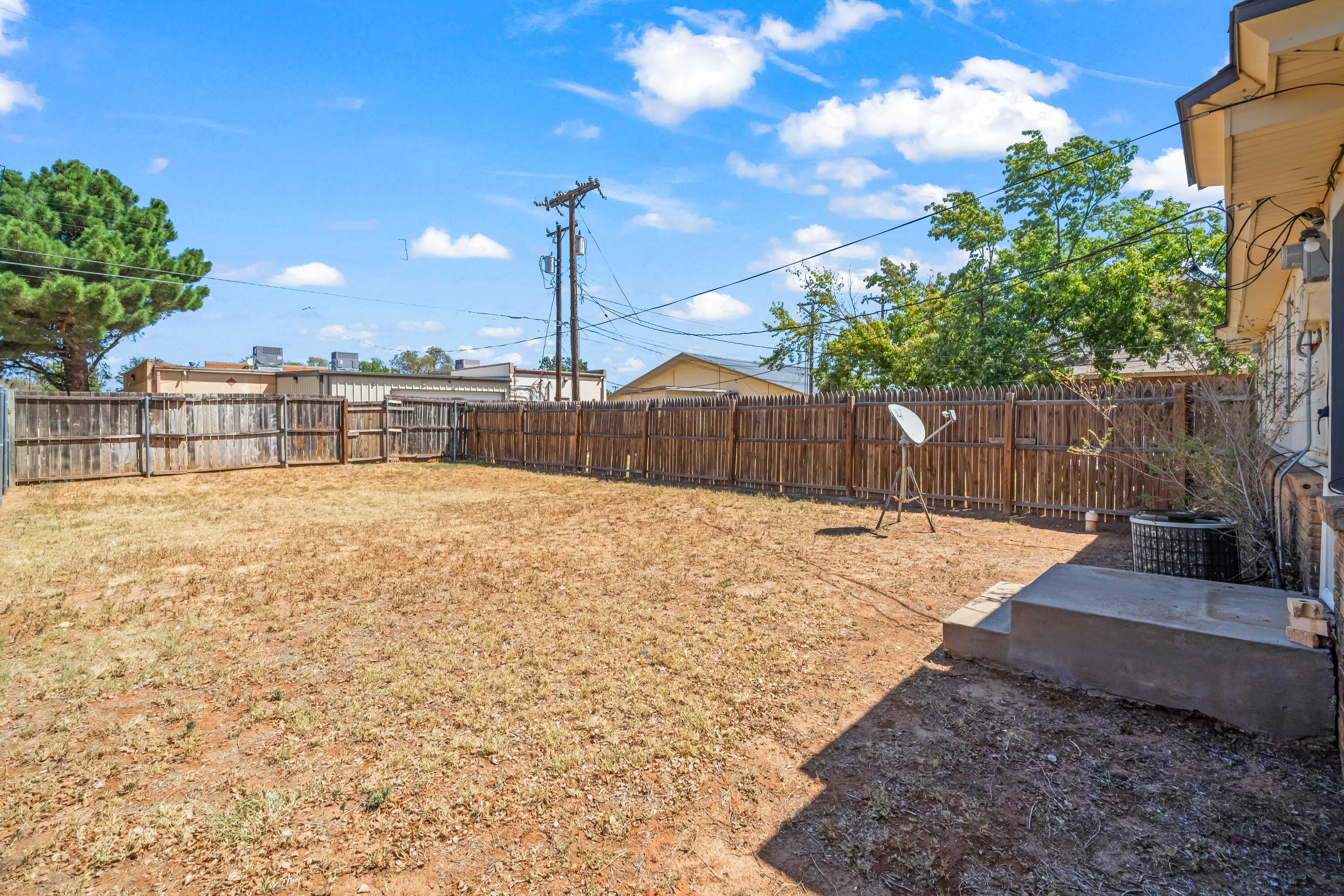 1718 46th Street Lubbock, TX 79412 - Photo 16 of 17 a swimming pool with outdoor seating and yard