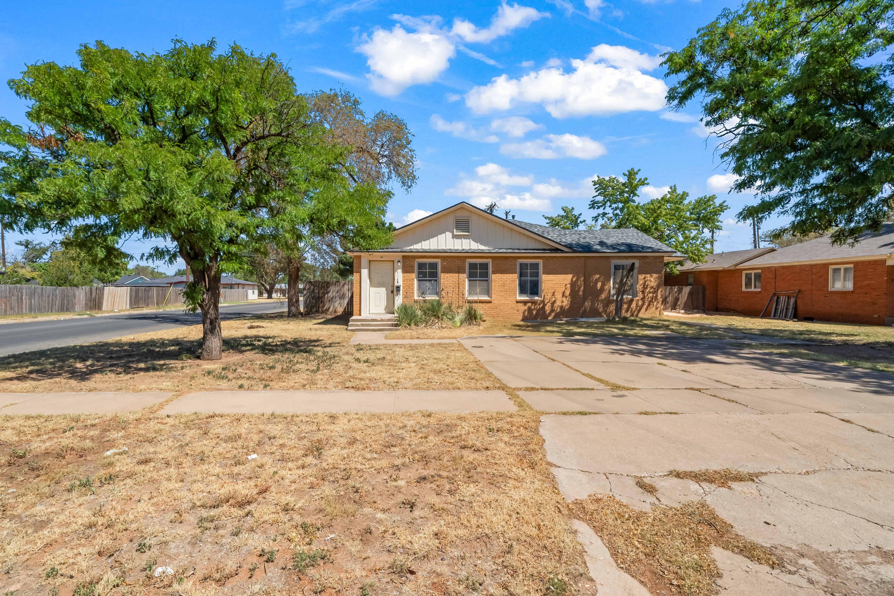 1718 46th Street Lubbock, TX 79412 - Photo 17 of 17 a front view of a house with a yard