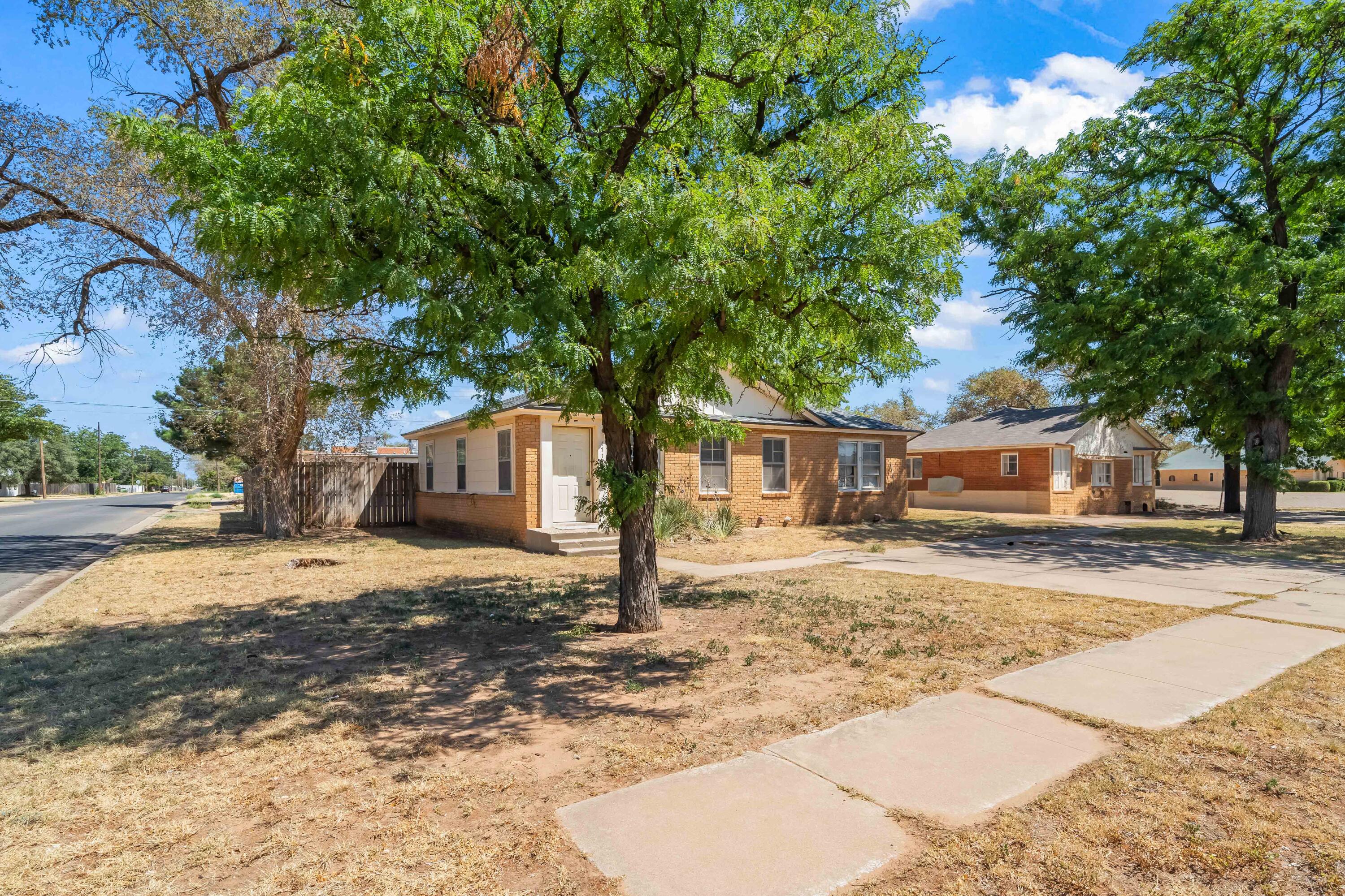 1718 46th Street Lubbock, TX 79412 - Photo 2 of 17 a tree in front of a white house