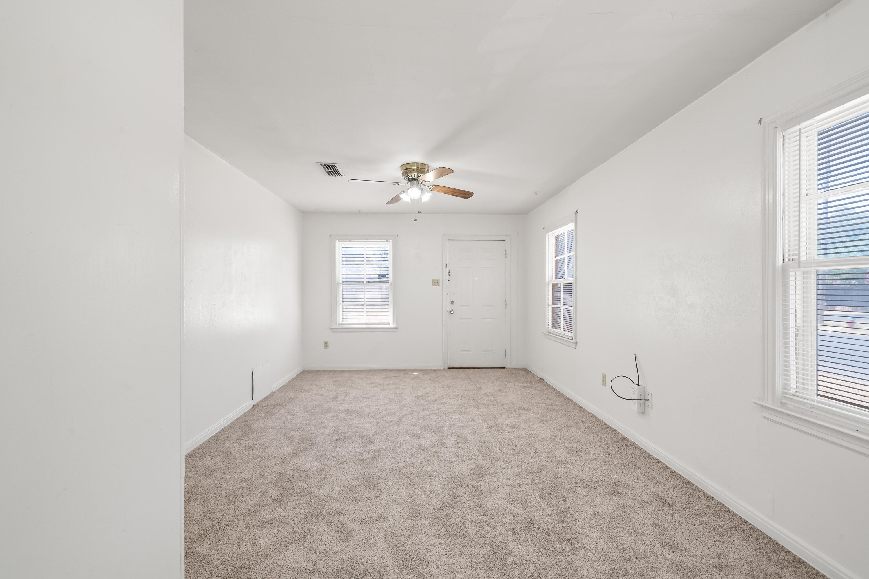 1718 46th Street Lubbock, TX 79412 - Photo 3 of 17 an empty room with windows and closet