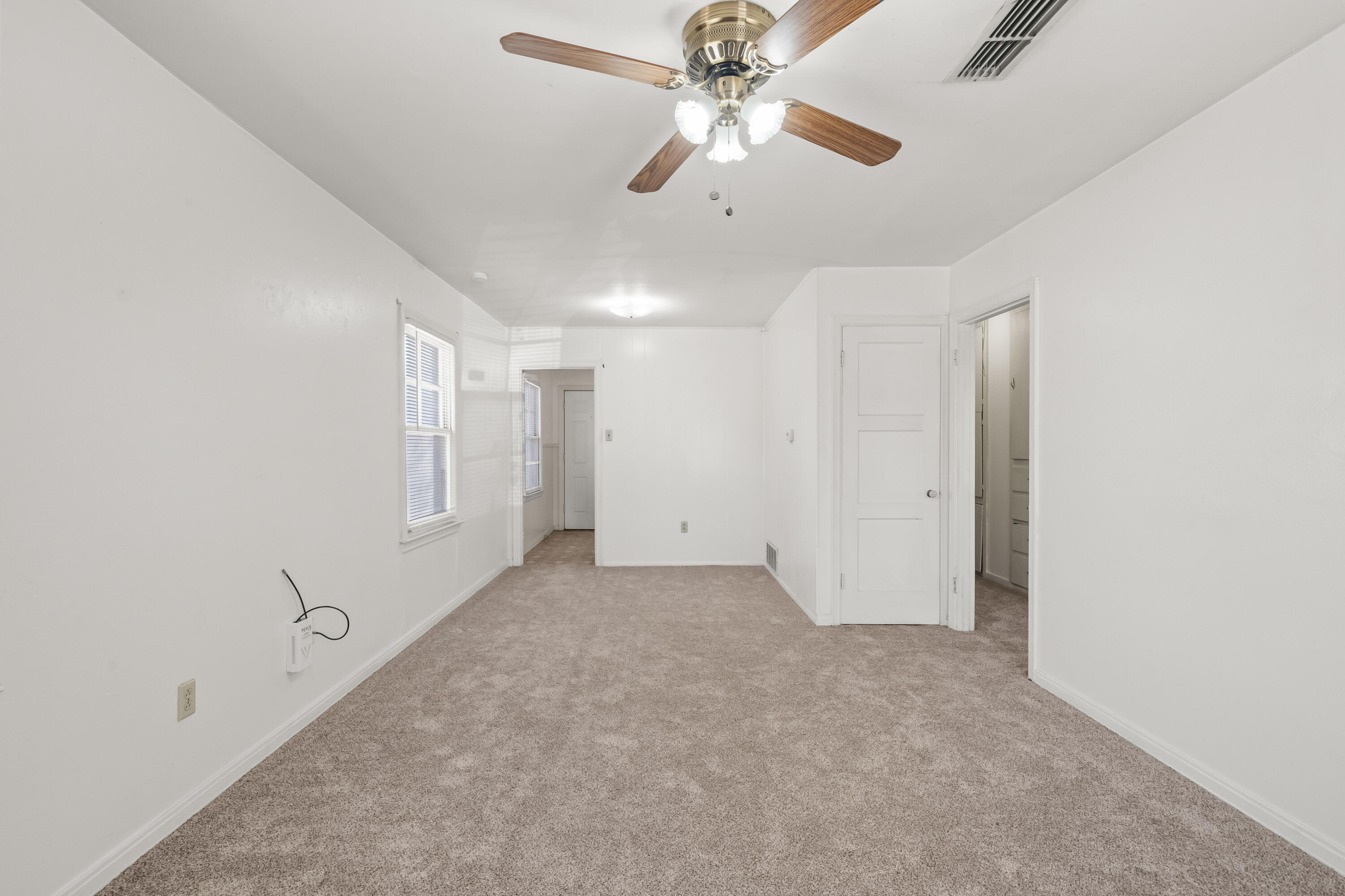 1718 46th Street Lubbock, TX 79412 - Photo 5 of 17 an empty room with chandelier fan