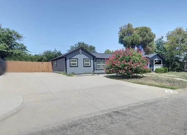 a house with lots of trees in the background