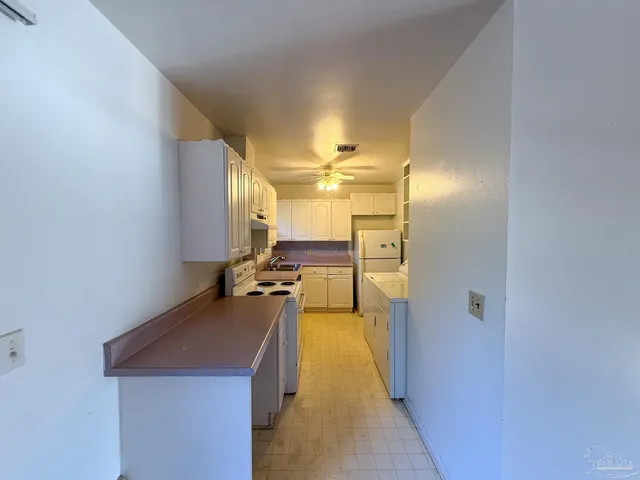 a kitchen with a sink and a refrigerator