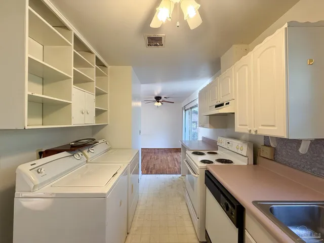 a kitchen that has a sink and a stove in it