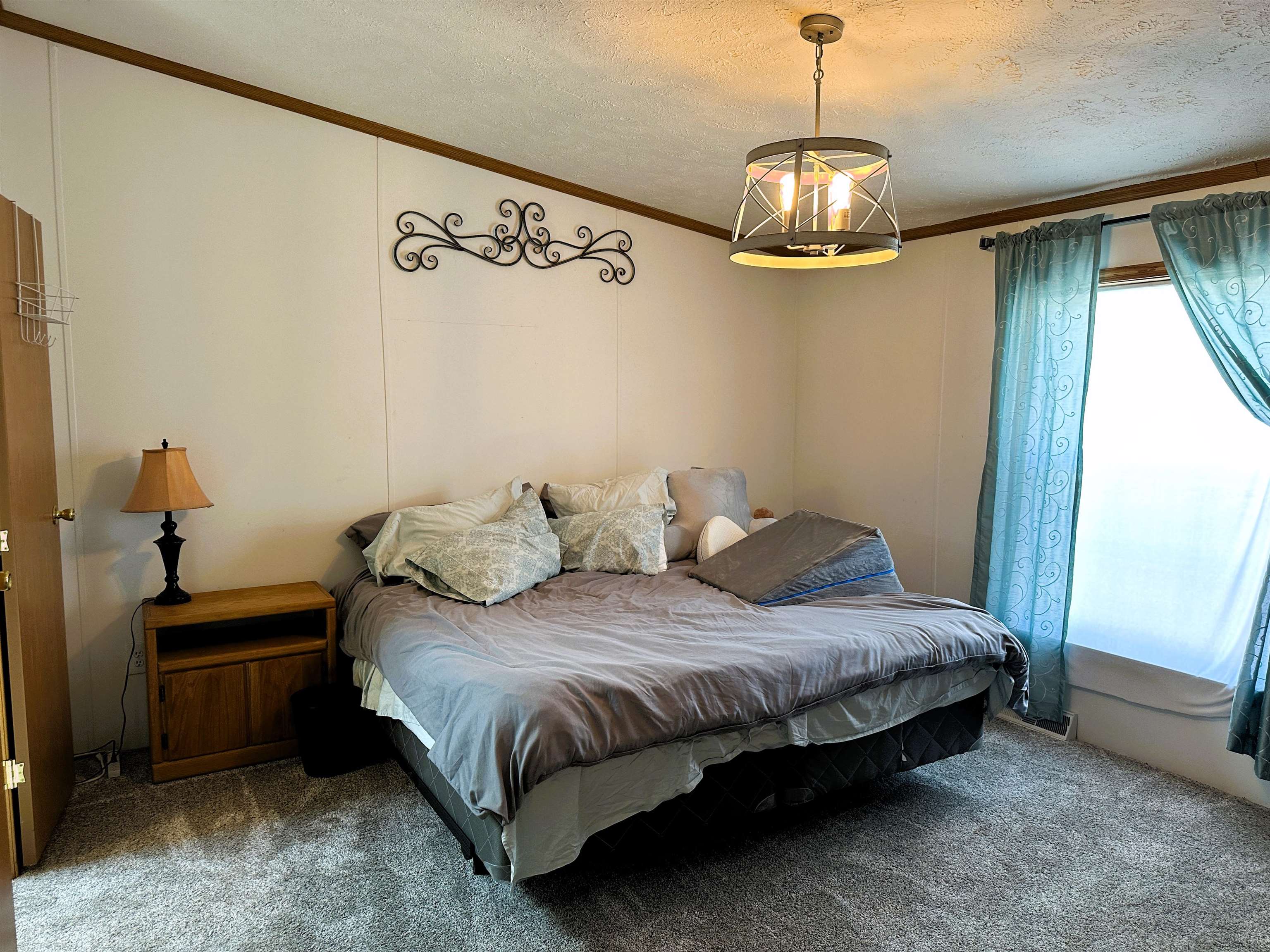291 Highway 2 Dixon, IL 61021 - Photo 14 of 27 a spacious bedroom with a bed and a chandelier