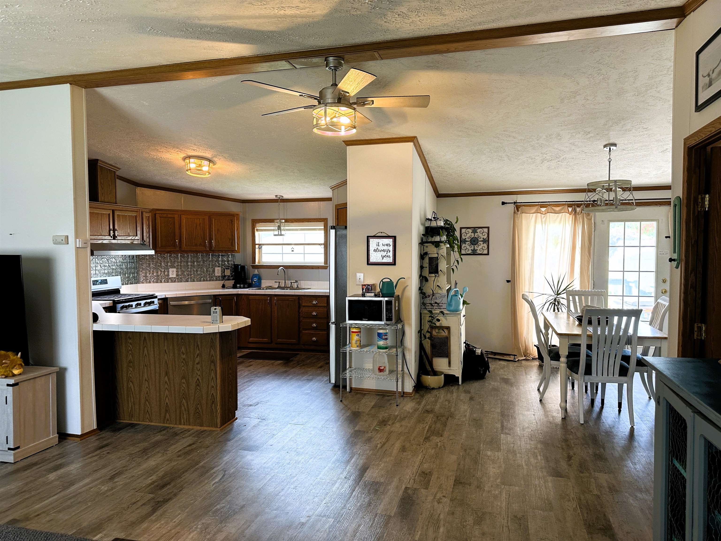291 Highway 2 Dixon, IL 61021 - Photo 5 of 27 a kitchen with stainless steel appliances kitchen island granite countertop a stove top oven a sink dishwasher a dining table and chairs with wooden floor