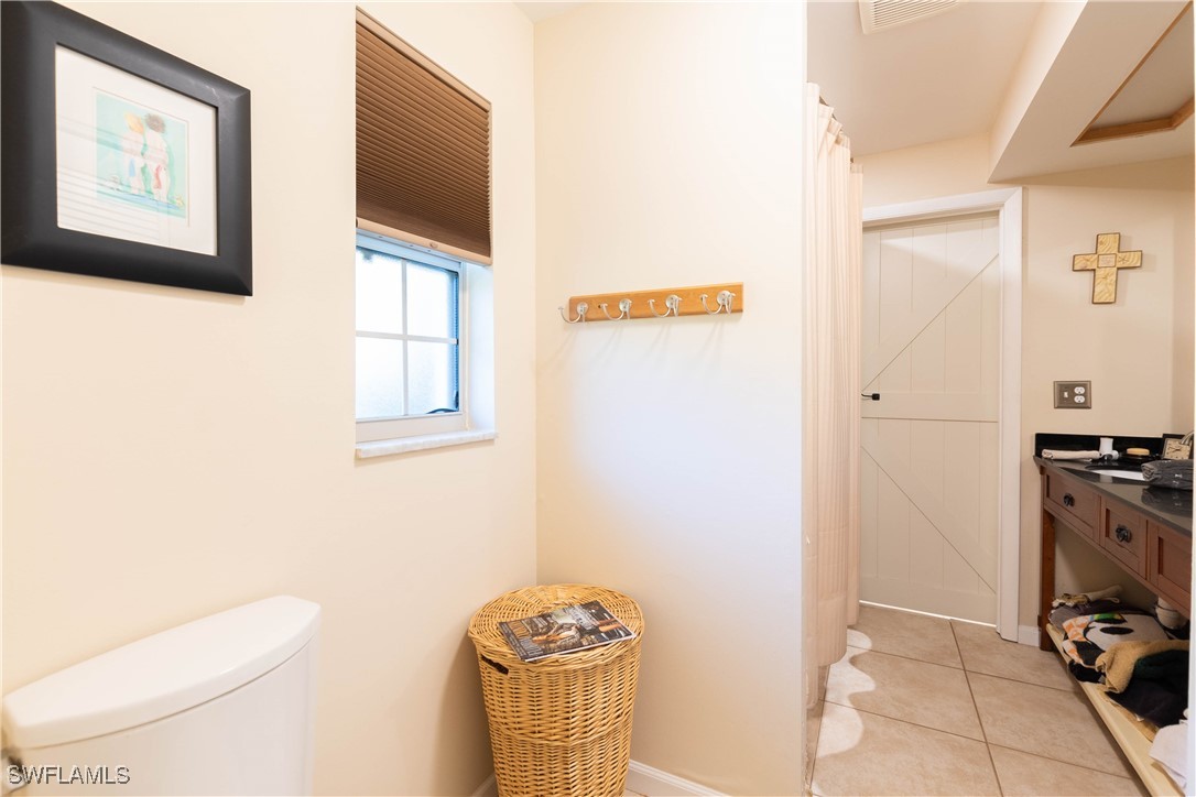 22591 Tuckahoe Road Alva, FL 33920 - Photo 19 of 28 a bathroom with a toilet and a shower