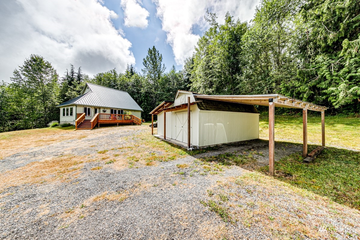976 Township Line Road Port Angeles, WA 98362 - Photo 32 of 40 a view of a house with backyard and trees in the background
