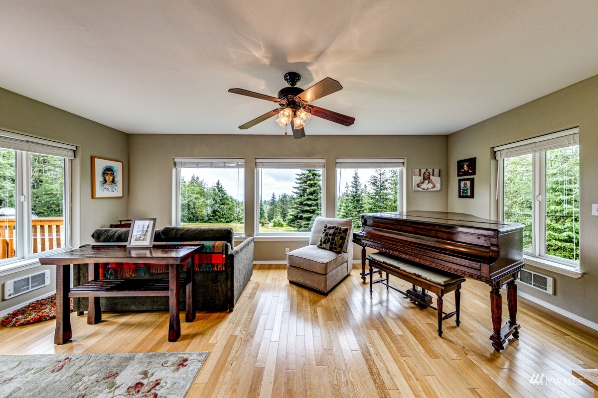 976 Township Line Road Port Angeles, WA 98362 - Photo 7 of 40 a living room with furniture a piano and a large window