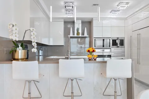 a kitchen with stainless steel appliances white cabinets and a sink