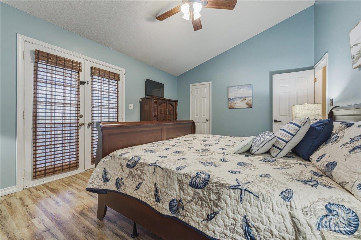 26063 Canal Road, Unit 3F Orange Beach, AL 36561 - Photo 46 of 72 a bedroom with a large bed and a chandelier