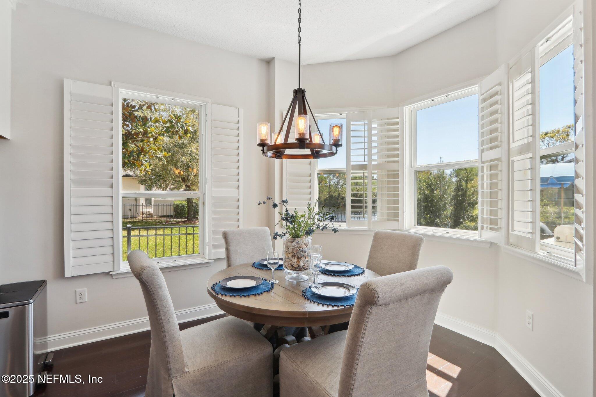 212 Cornwall Drive Ponte Vedra, FL 32081 - Photo 13 of 84 a dining room with furniture a chandelier and wooden floor