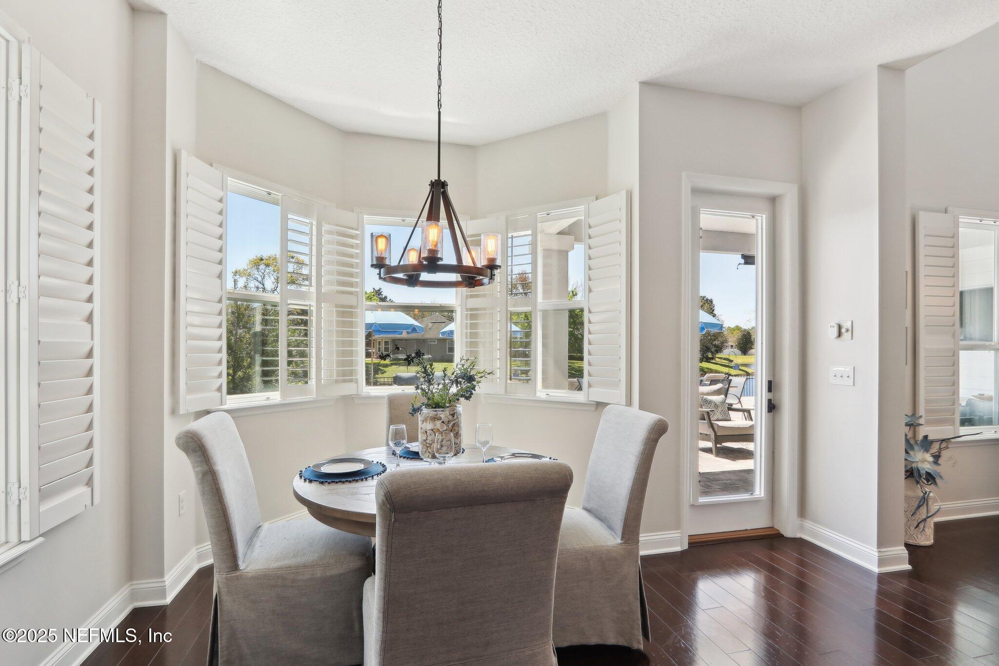 212 Cornwall Drive Ponte Vedra, FL 32081 - Photo 14 of 84 a view of a dining room with furniture window and wooden floor