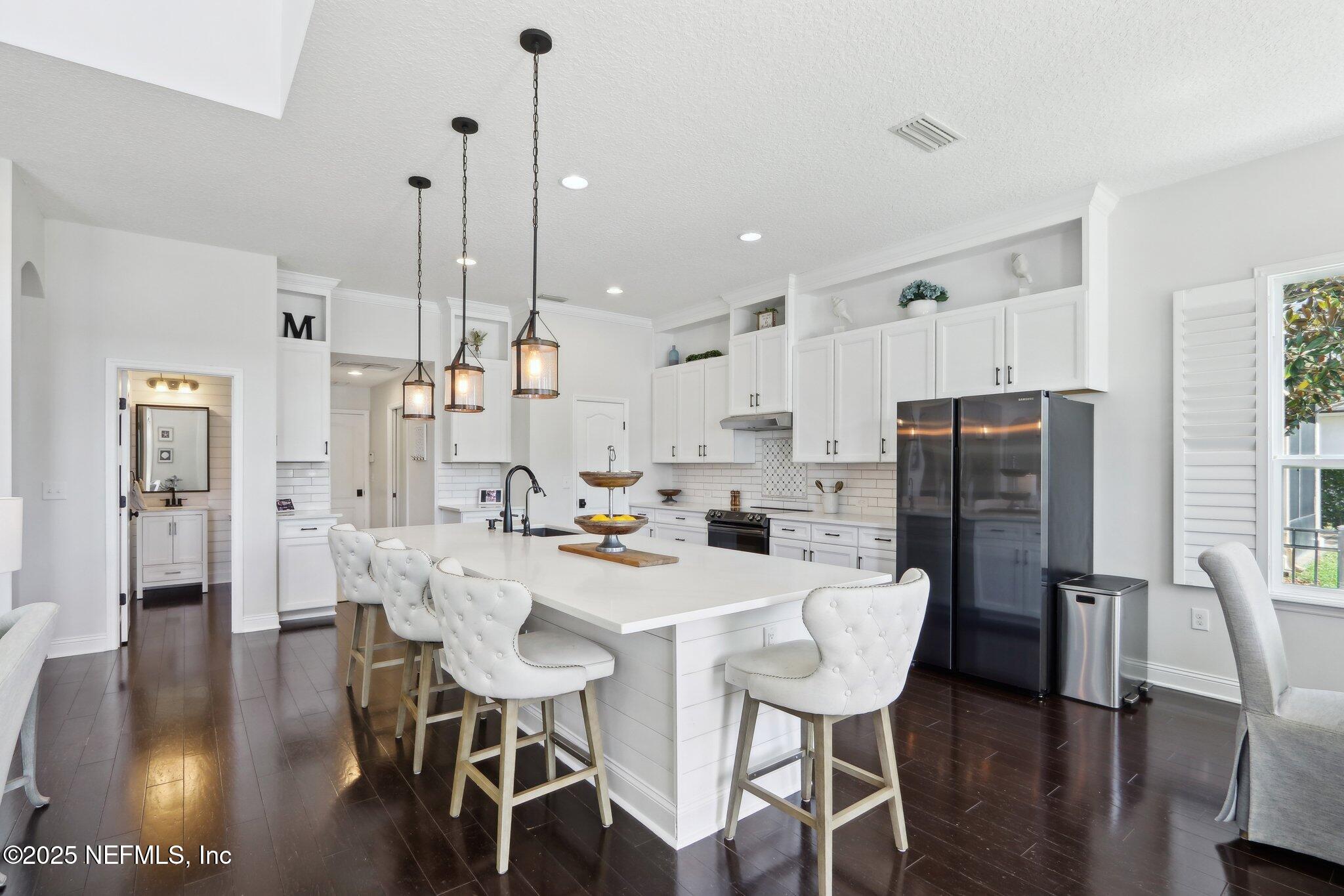 212 Cornwall Drive Ponte Vedra, FL 32081 - Photo 16 of 84 a view of a dining room with furniture and wooden floor