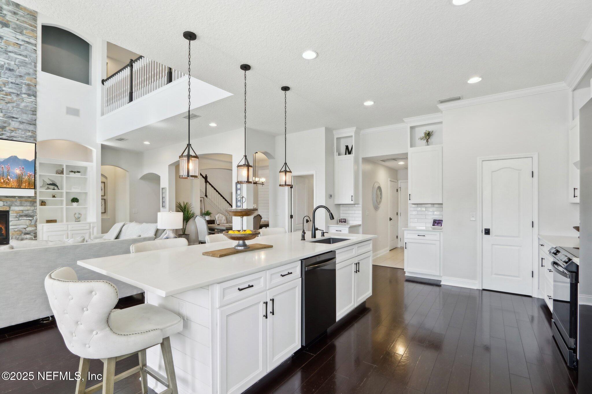 212 Cornwall Drive Ponte Vedra, FL 32081 - Photo 17 of 84 a kitchen with stainless steel appliances kitchen island a sink and a refrigerator