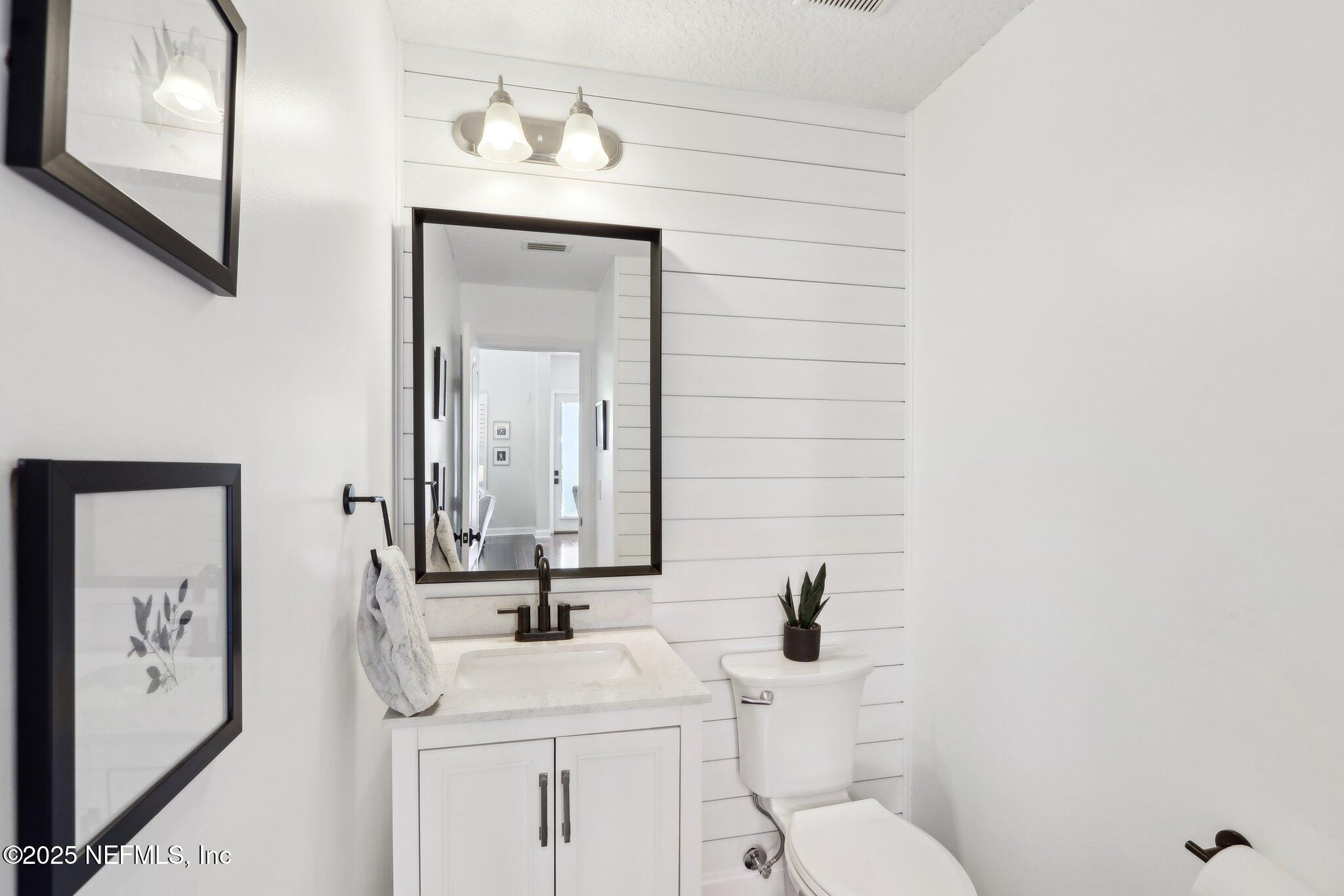 212 Cornwall Drive Ponte Vedra, FL 32081 - Photo 20 of 84 a bathroom with a sink a toilet and mirror