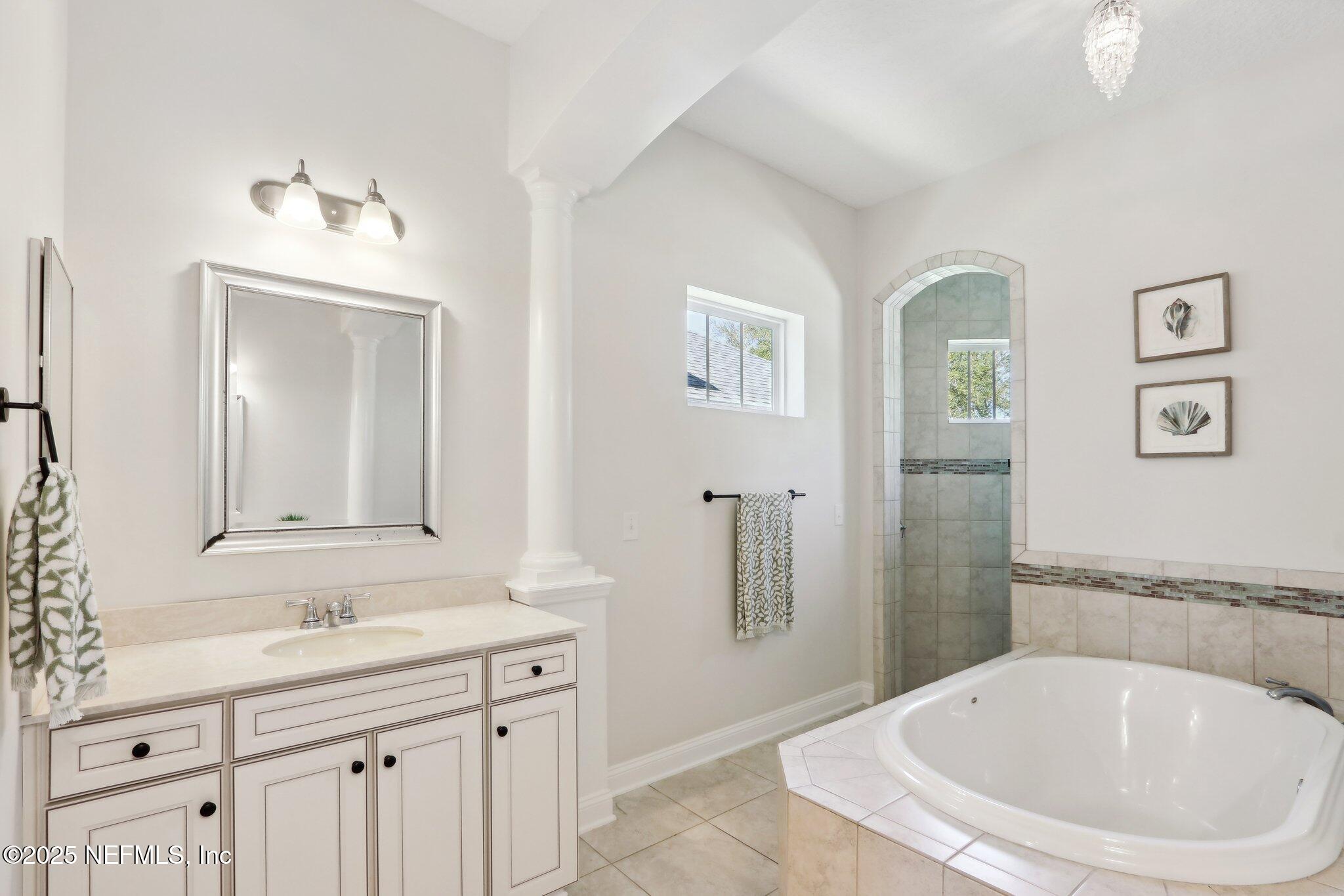 212 Cornwall Drive Ponte Vedra, FL 32081 - Photo 30 of 84 a bathroom with a granite countertop sink a mirror a bathtub and a shower