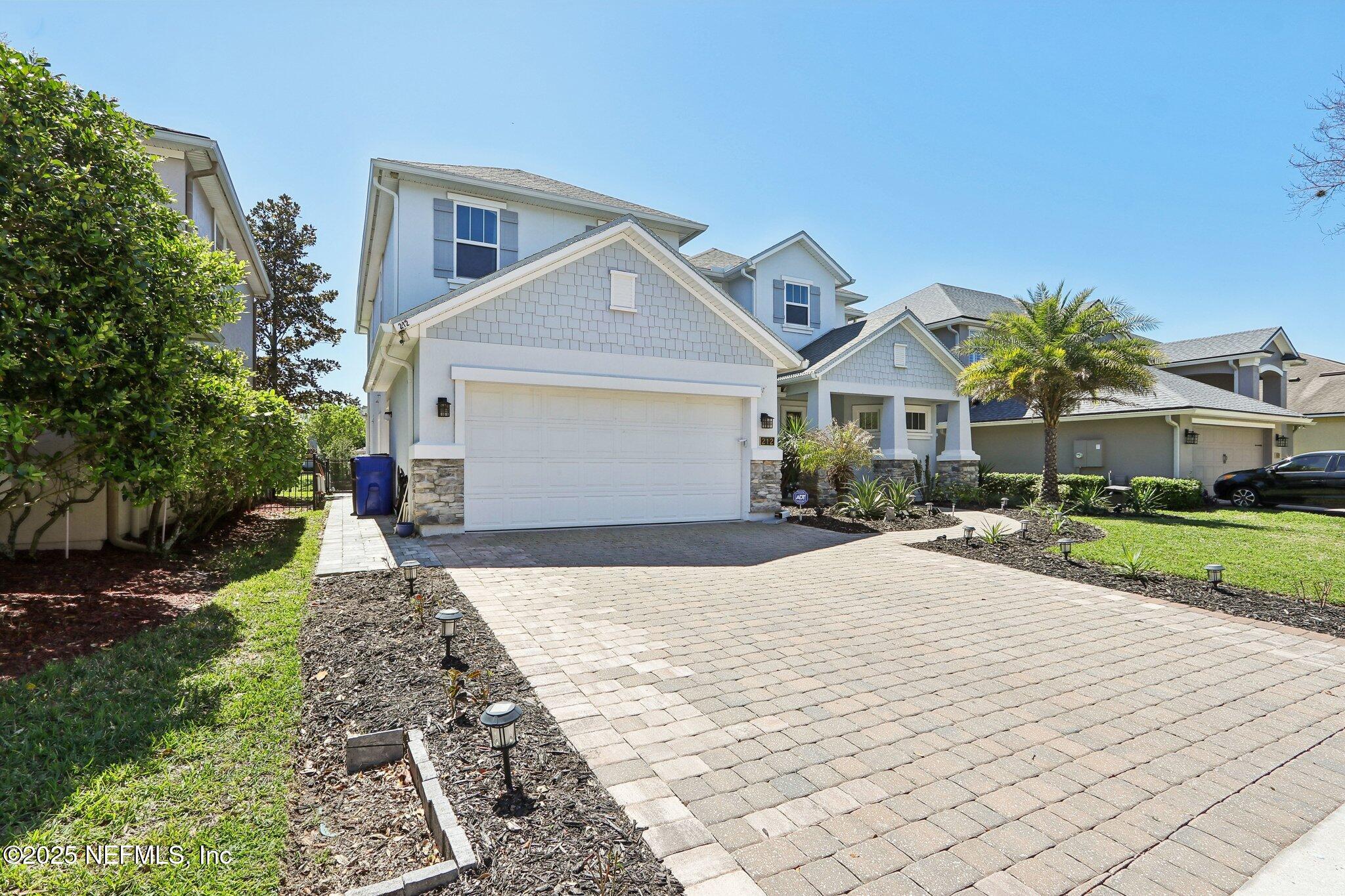 212 Cornwall Drive Ponte Vedra, FL 32081 - Photo 3 of 84 a front view of a house with a yard and garage