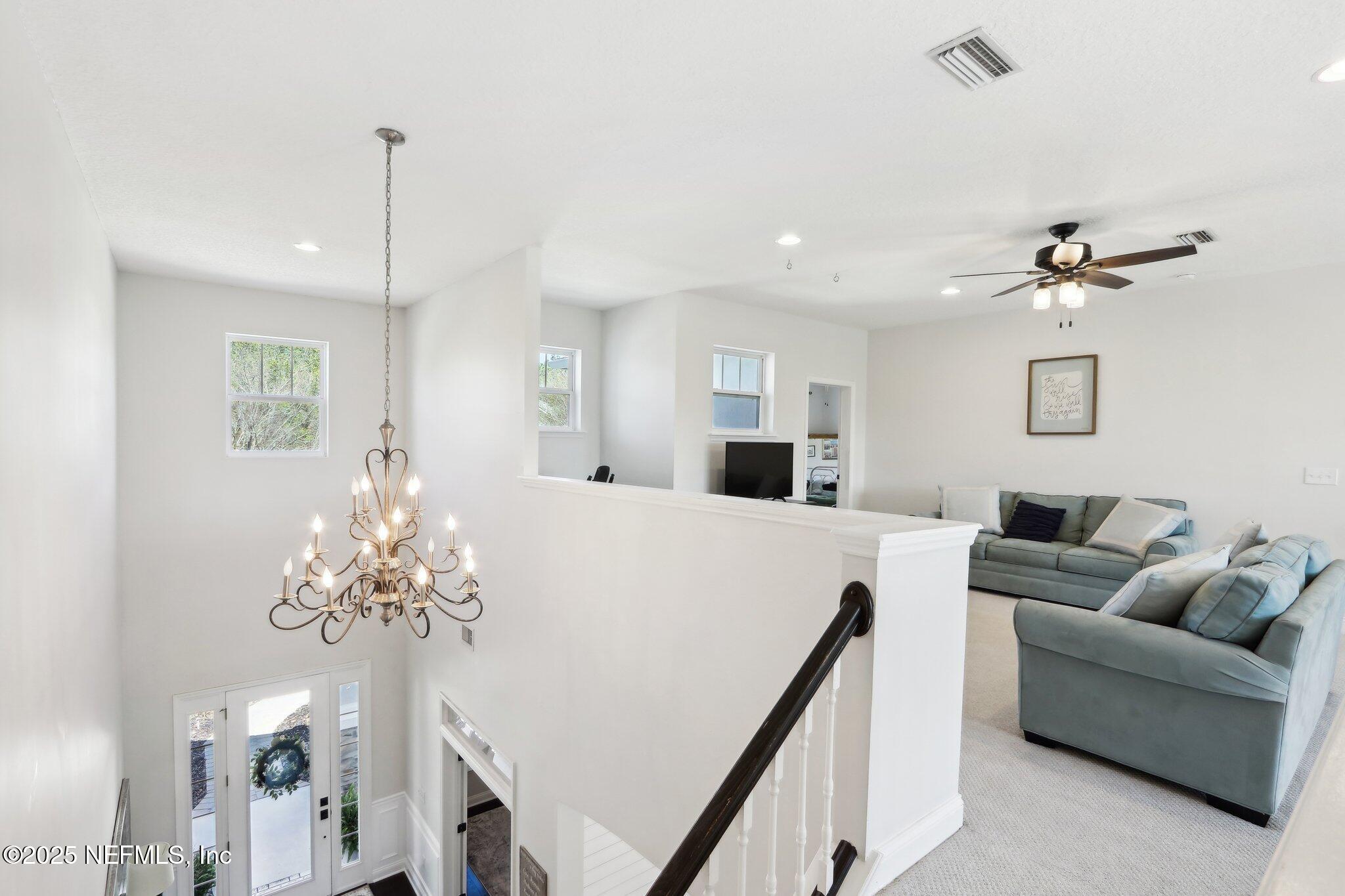 212 Cornwall Drive Ponte Vedra, FL 32081 - Photo 32 of 84 a living room with furniture and a chandelier
