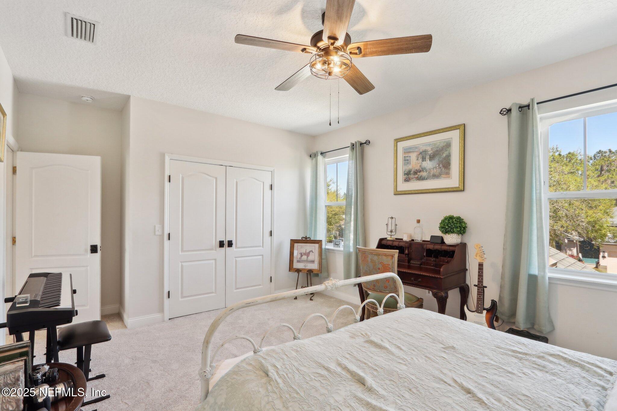 212 Cornwall Drive Ponte Vedra, FL 32081 - Photo 37 of 84 a bedroom with a bed and a chandelier