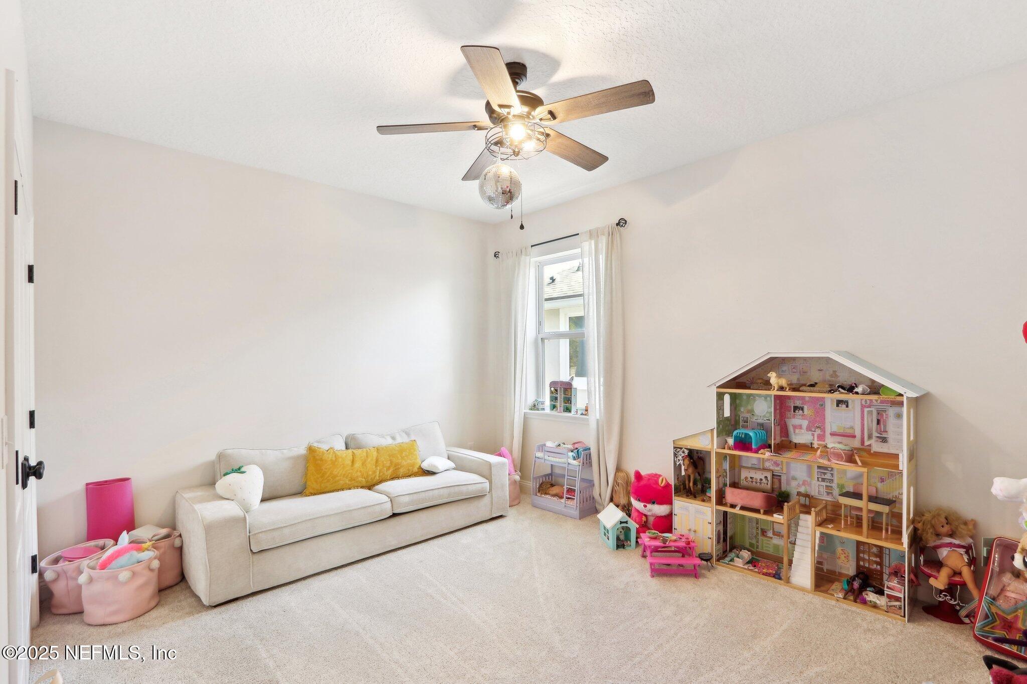 212 Cornwall Drive Ponte Vedra, FL 32081 - Photo 38 of 84 a living room with furniture and a chandelier