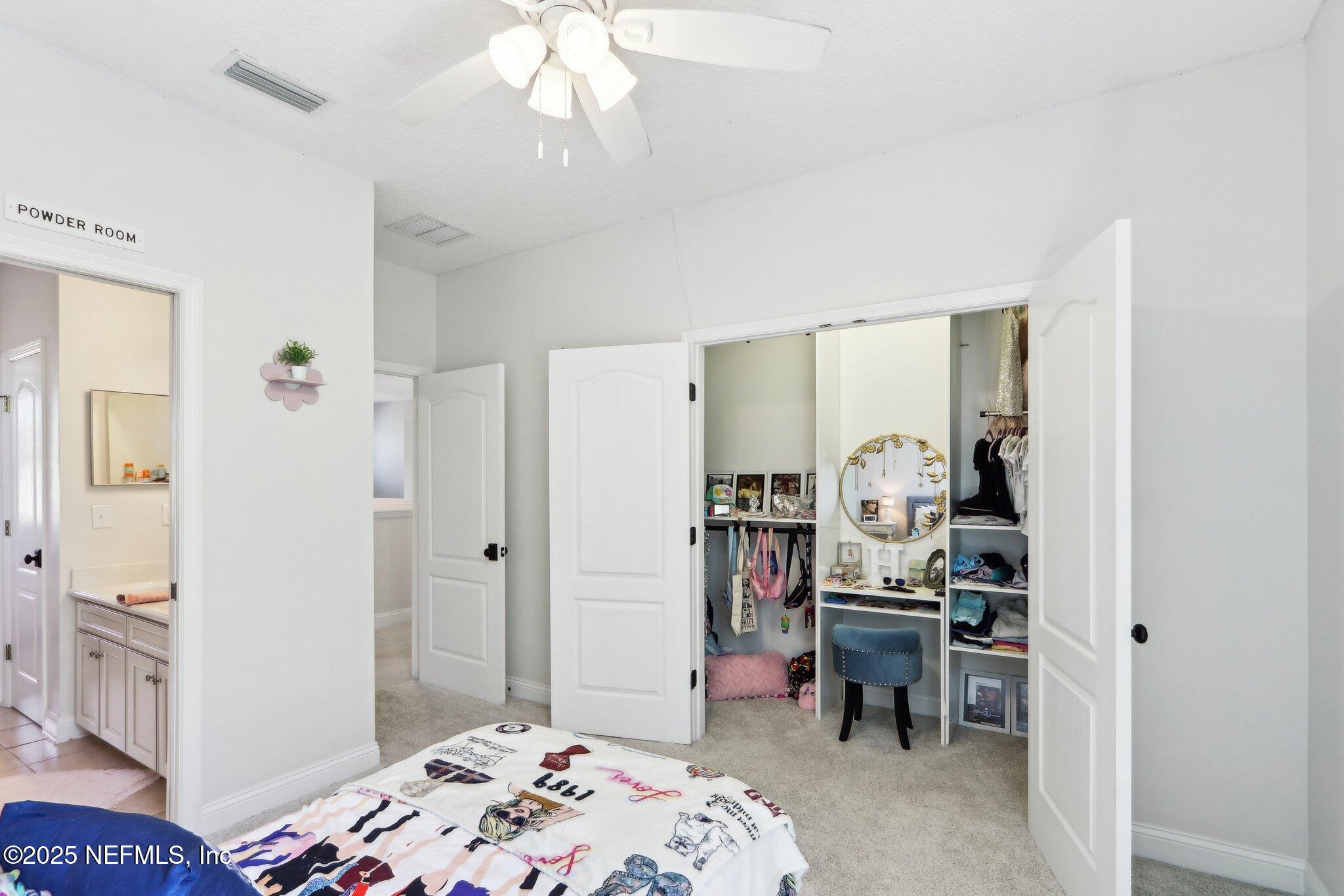 212 Cornwall Drive Ponte Vedra, FL 32081 - Photo 44 of 84 a bedroom with a bed and a chandelier