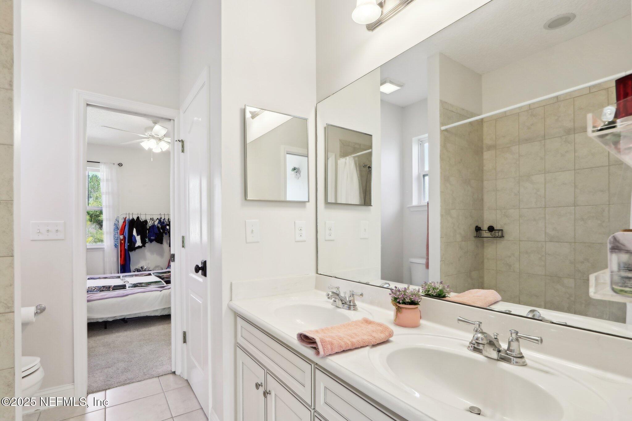 212 Cornwall Drive Ponte Vedra, FL 32081 - Photo 46 of 84 a en suite bathroom with a double sink shower and a mirror