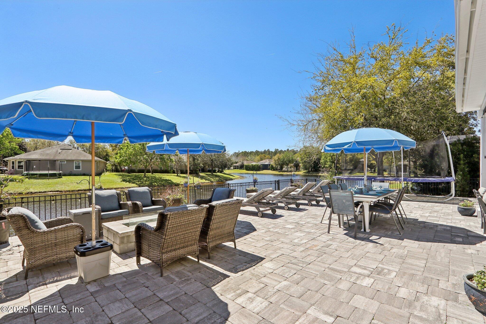 212 Cornwall Drive Ponte Vedra, FL 32081 - Photo 54 of 84 a view of a patio with a table and chairs under an umbrella