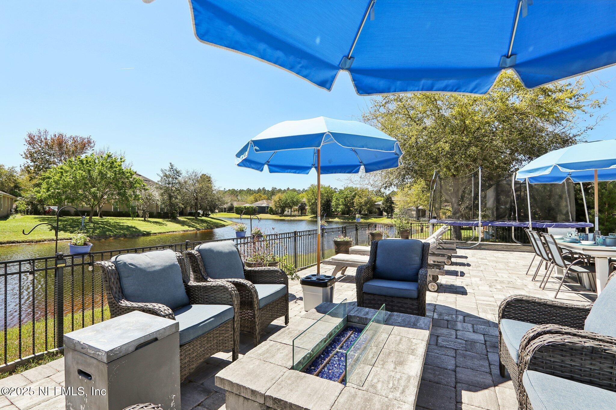212 Cornwall Drive Ponte Vedra, FL 32081 - Photo 55 of 84 a view of a patio with couches chairs under an umbrella