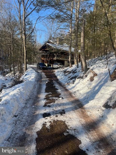 140 Clay Ridge Road Ottsville, PA 18942 - Photo 3 of 10 Charming cabin nestled in a snowy forest.