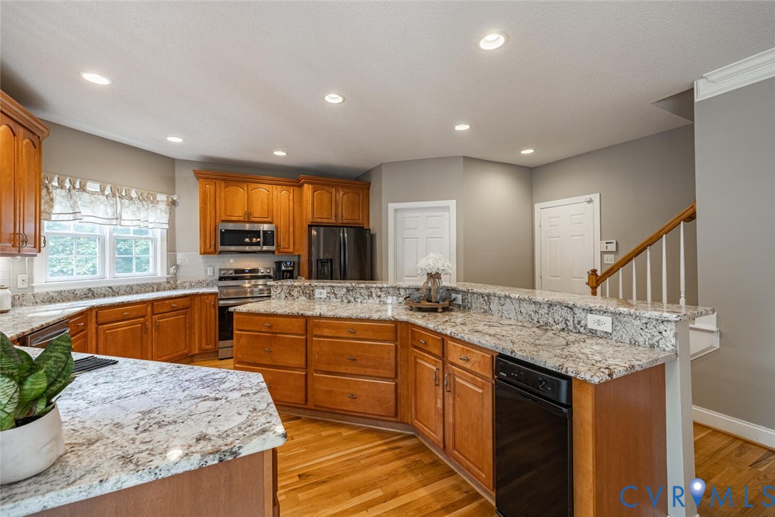 15021 River Road Chesterfield, VA 23838 - Photo 12 of 50 a kitchen with stainless steel appliances granite countertop sink stove and granite counter top