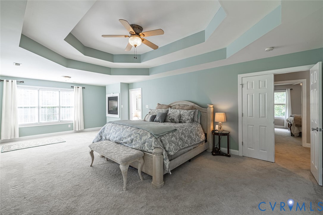 15021 River Road Chesterfield, VA 23838 - Photo 21 of 50 a spacious bedroom with a bed and a chandelier