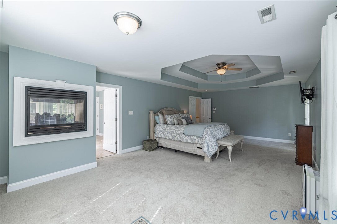 15021 River Road Chesterfield, VA 23838 - Photo 22 of 50 a room with a bed and a chandelier
