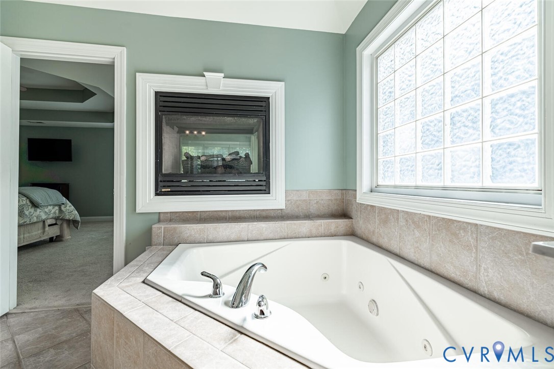 15021 River Road Chesterfield, VA 23838 - Photo 25 of 50 a bathroom with a bathtub and a window