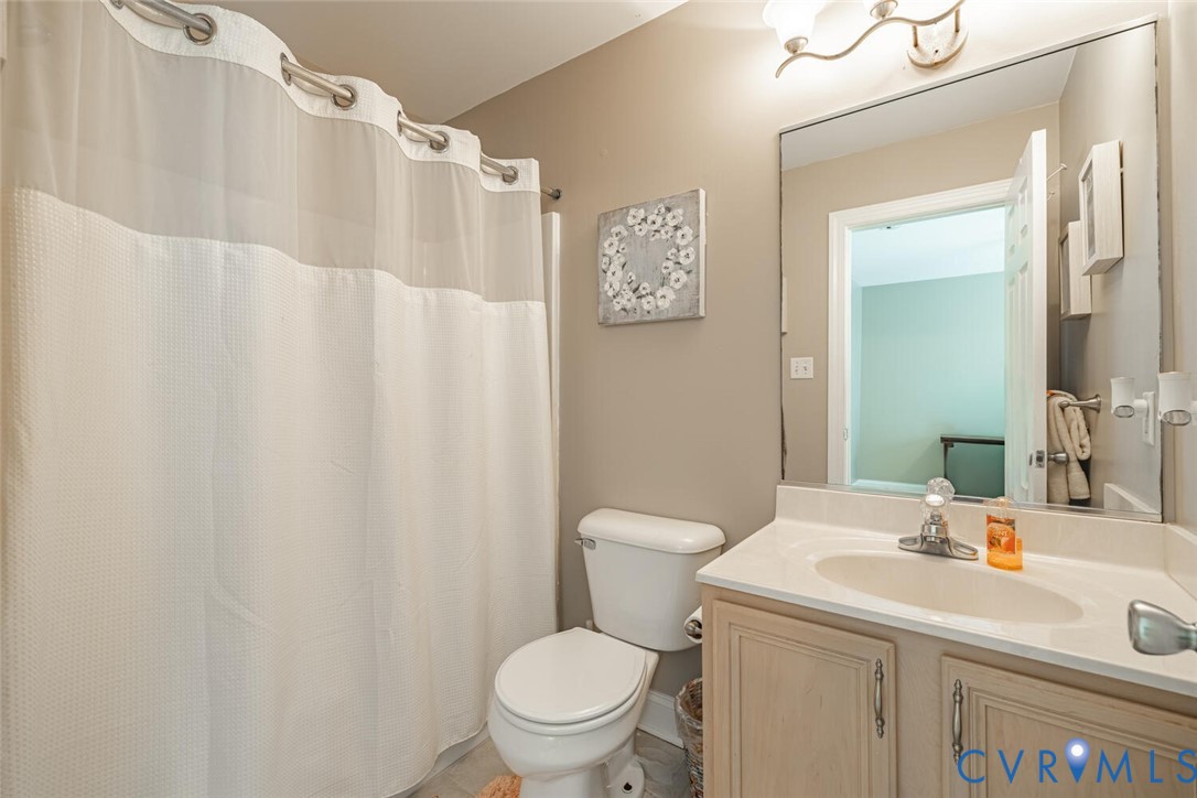 15021 River Road Chesterfield, VA 23838 - Photo 31 of 50 a bathroom with a sink a toilet and a mirror