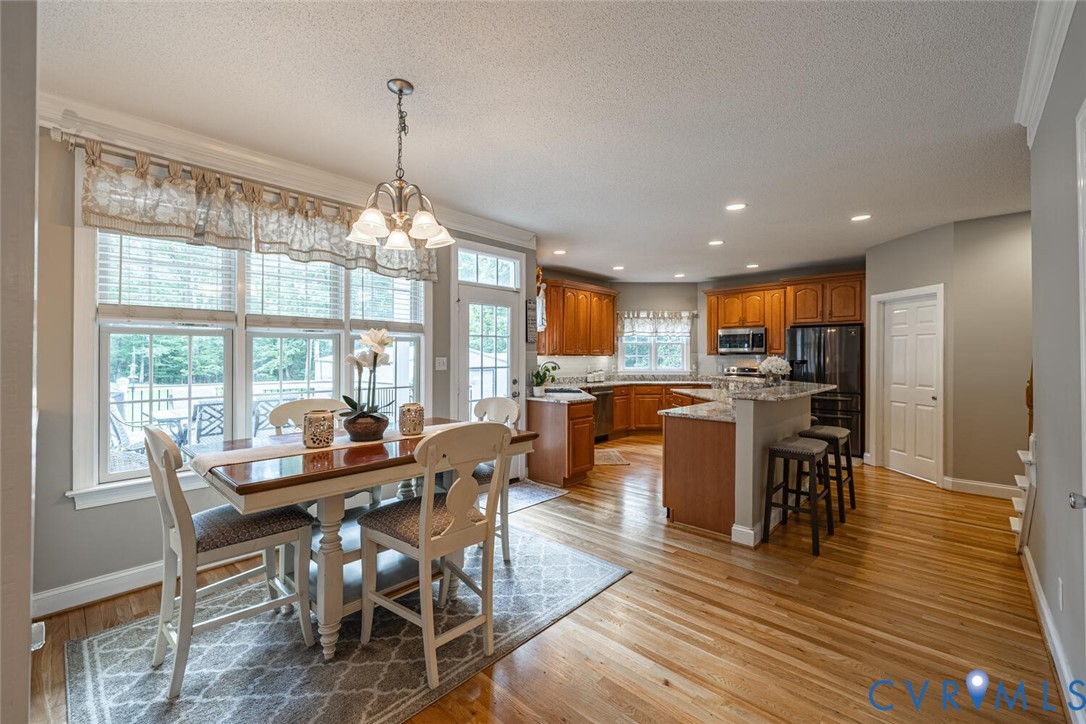15021 River Road Chesterfield, VA 23838 - Photo 10 of 50 a view of a dining room with furniture window and wooden floor