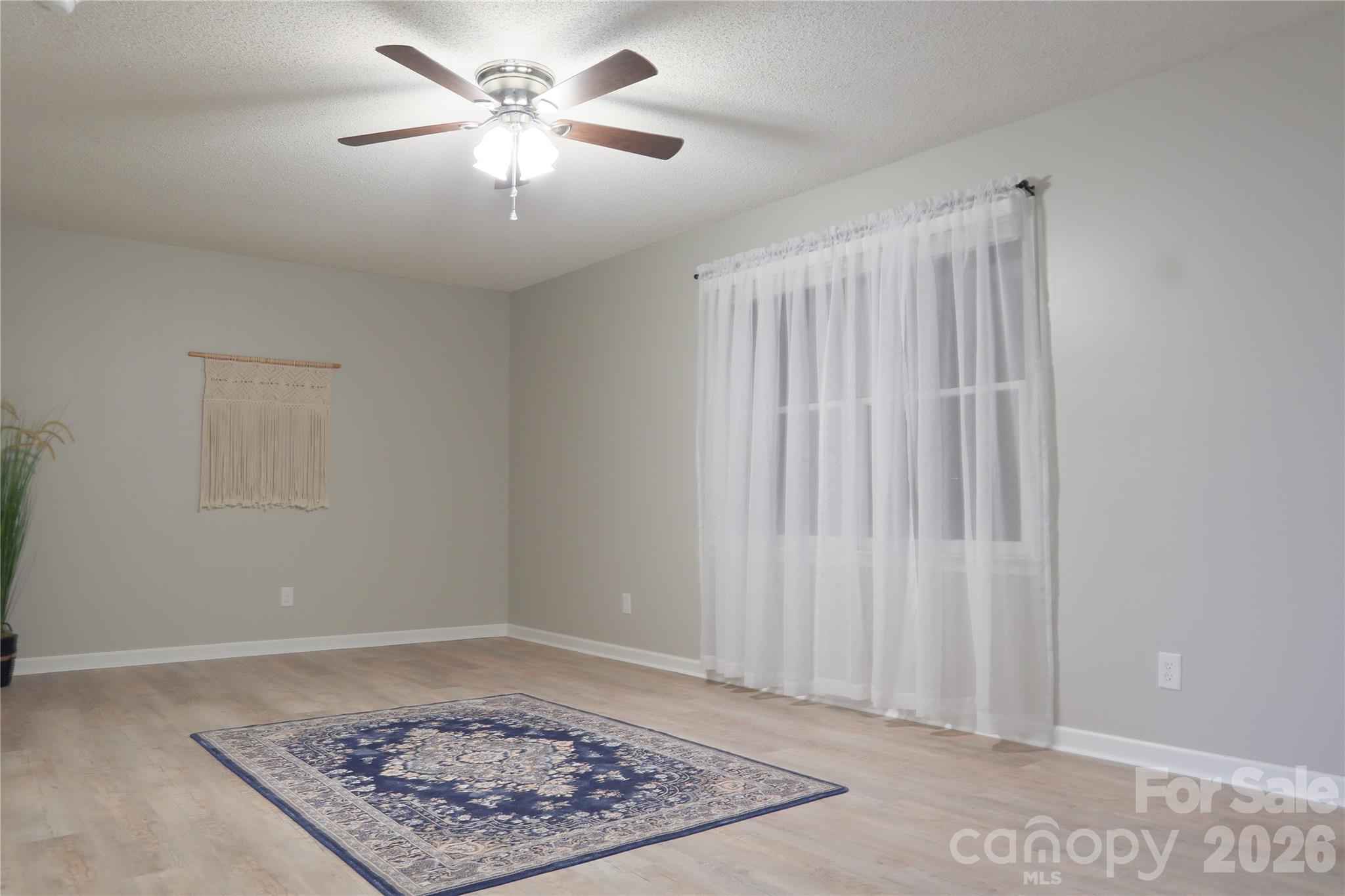 525 12th Street Southwest, Unit 26 Hickory, NC 28602 - Photo 4 of 21 a view of a room with a window and a ceiling fan