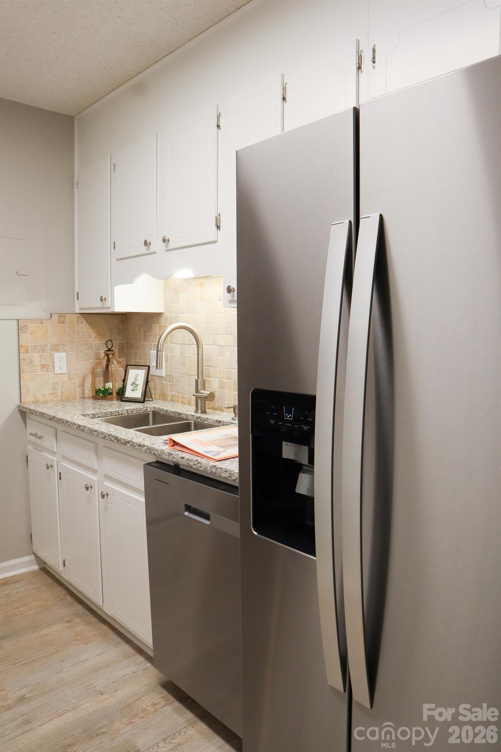525 12th Street Southwest, Unit 26 Hickory, NC 28602 - Photo 5 of 21 a kitchen with stainless steel appliances granite countertop a refrigerator and a sink