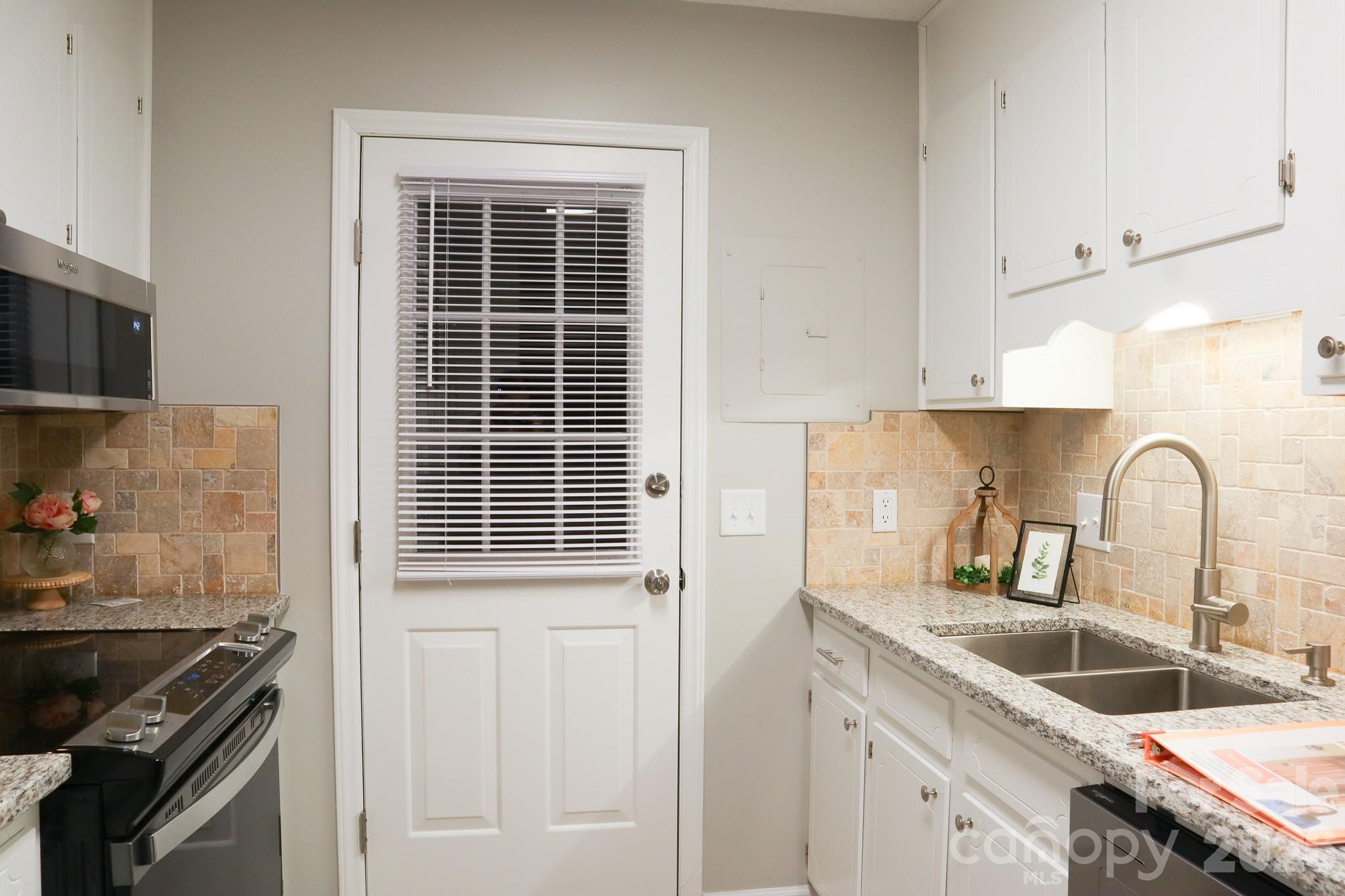 525 12th Street Southwest, Unit 26 Hickory, NC 28602 - Photo 7 of 21 a kitchen with granite countertop a sink stove and cabinets