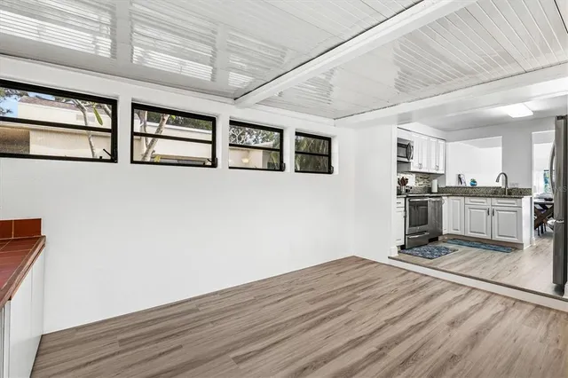 a room with stainless steel appliances granite countertop a stove and a refrigerator