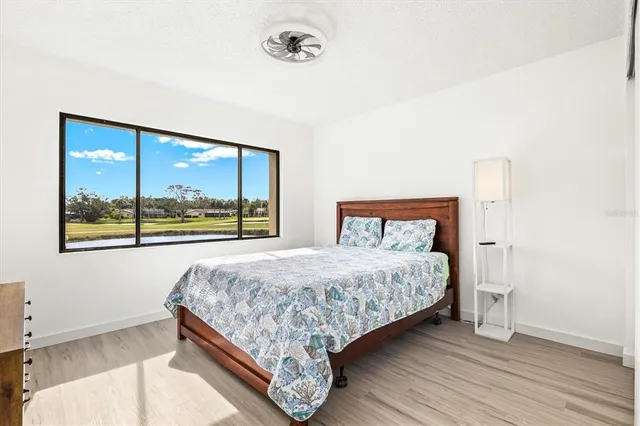 a view of a living room and bathroom with wooden floor