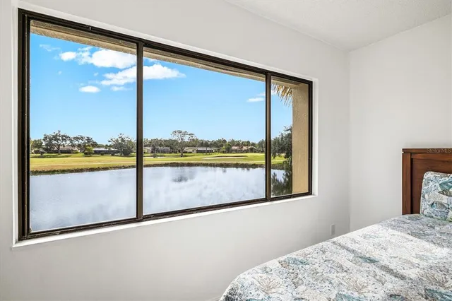 a view of a room with wooden floor and cabinets
