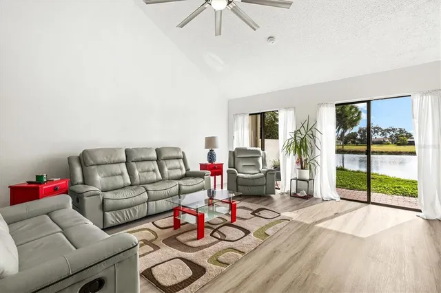 a living room with furniture and a floor to ceiling window