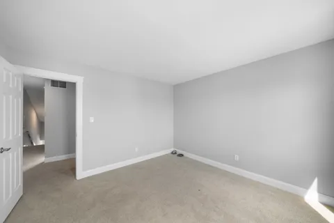 a view of an empty room and closet area