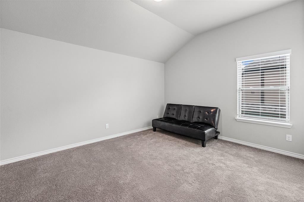 437 Prairie Run Aledo, TX 76008 - Photo 26 of 33 Spacious room featuring vaulted ceilings, light gray wall paint, and gray carpeted flooring