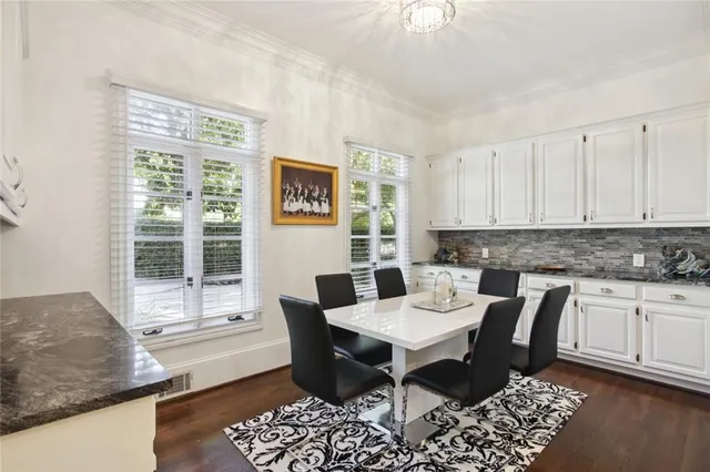 a view of a kitchen area with furniture and wooden floor