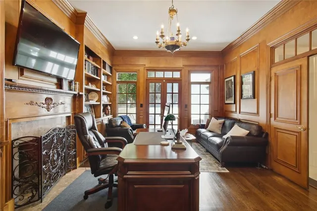 a living room with furniture and a chandelier