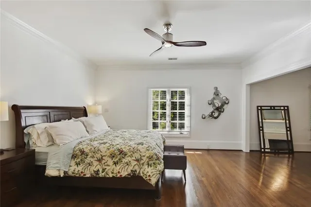 a bedroom with a large bed and a window